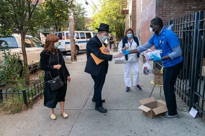 Volunteers and city workers from different departments including Test and Trace Corpand City Health + Hospitals distributed masks and hand sanitizers this week in Brooklyn.